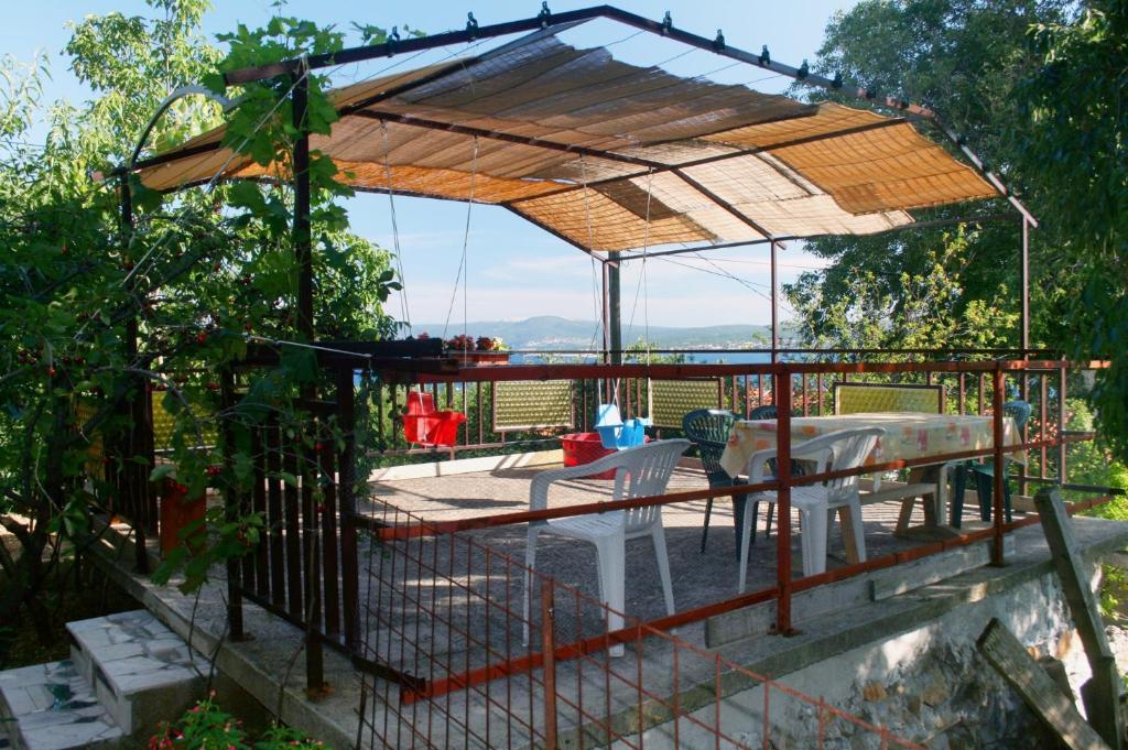 a gazebo with a table and chairs on a deck at Apartments with parking space Dramalj, Crikvenica - 5491 in Dramalj