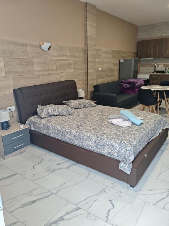 a bedroom with a bed and a couch at Gcm 3 rooms kentro κατερινη in Katerini