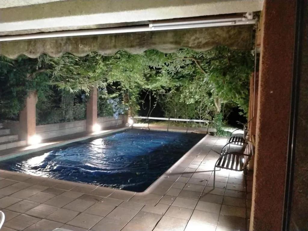 a swimming pool in a house with a patio at Spacious Villa with Pool in Cabeanca 250 m² in Ourense