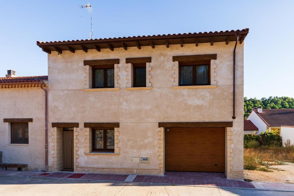 a large brick house with a garage at Casa Teresa in La Santa Espina