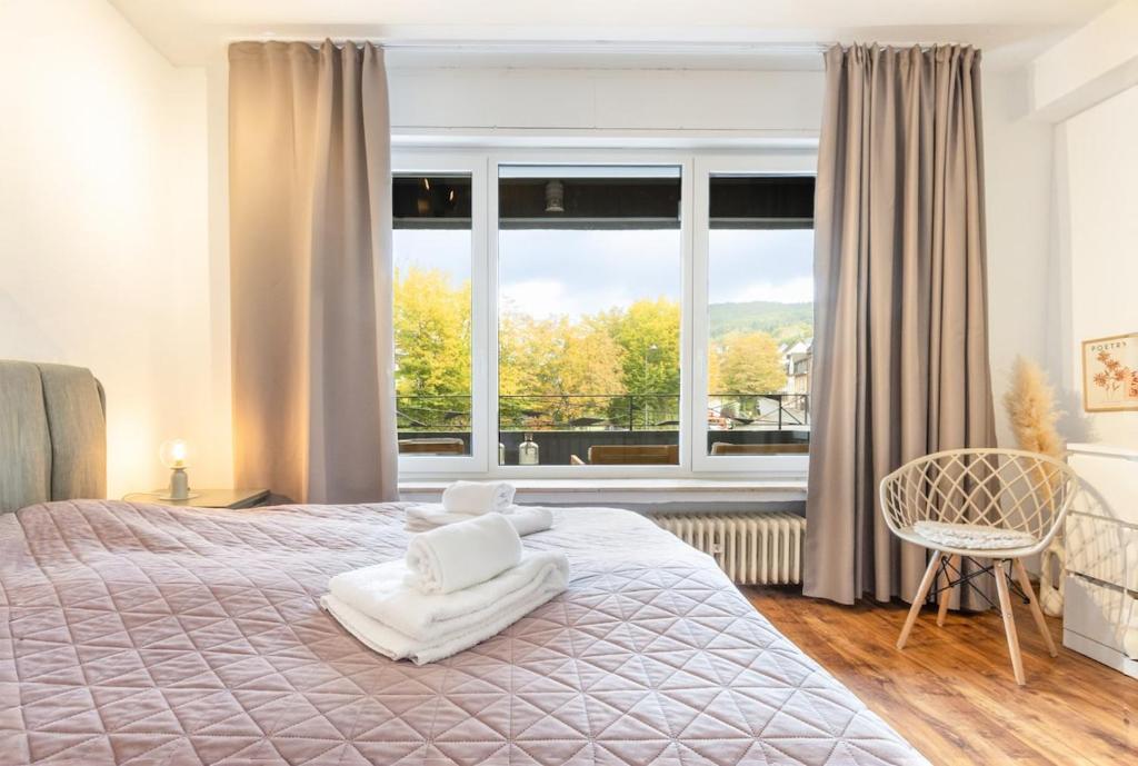 科赫姆Schöne Wohnung mit großer Terrasse und Moselblick的一间卧室，里面有一张床和一扇大窗户。