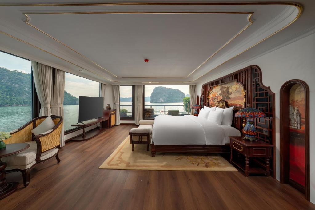 a bedroom with a large bed and a large window at L'amour Cruise in Ha Long