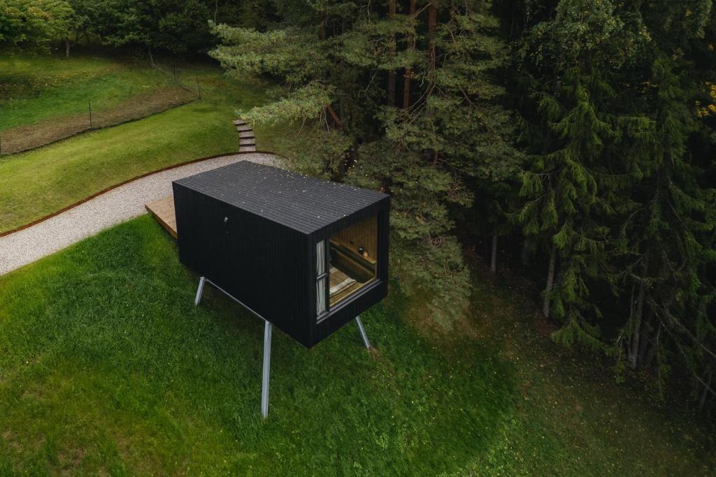 a black box sitting on top of a field of grass at Blackview cabin in Kulautuva