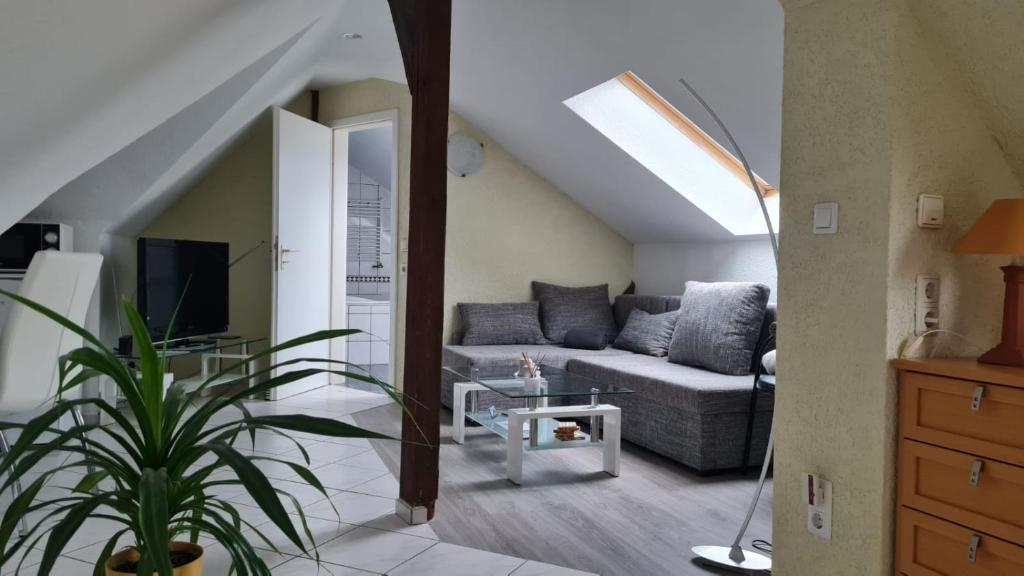 a living room with a couch and a tv at Ferienwohnung Blumenberg DG Karlstraße in Staßfurt