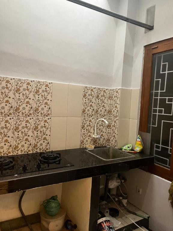 a kitchen with a sink and a counter top at Rama Shinta Guest House & Coffee in Timuran