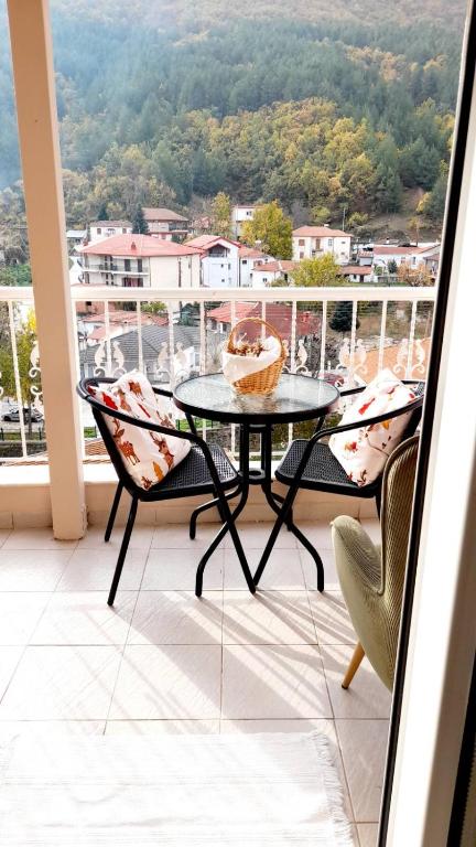 a table and chairs on a balcony with a view at Agapi apartment in Florina