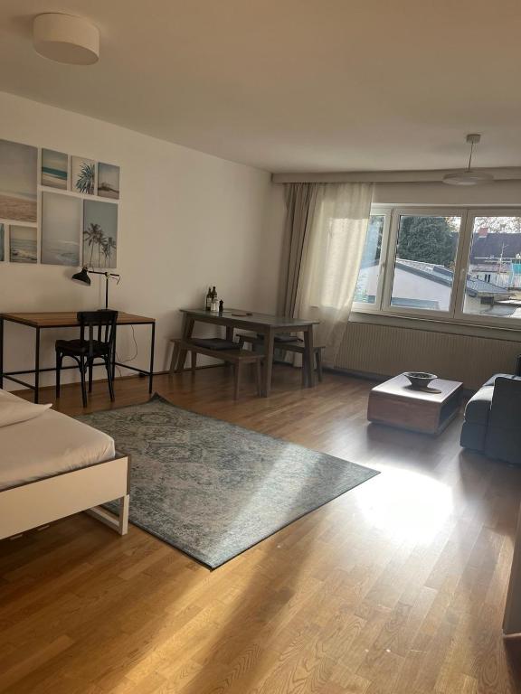 a living room with a couch and a table at Studios Harrachgasse FIVE in Graz