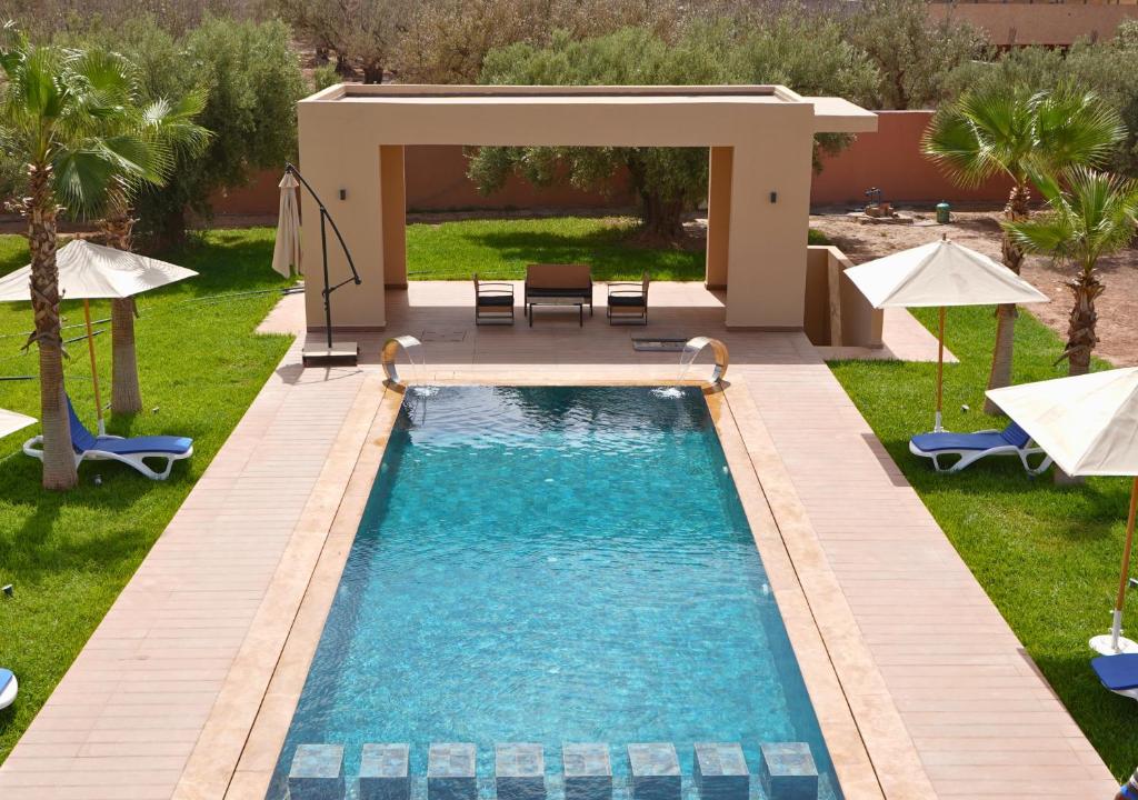 a swimming pool in the middle of a yard at Villa with Private Pool in Marrakech - Dar Mazar in Oubadine