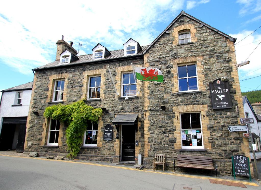 an old stone building on the corner of a street at The Eagles Bunkhouse in Betws-y-coed