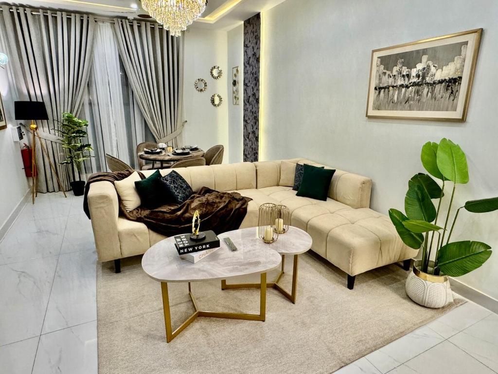 a living room with a couch and a table at 3BR Modern Home Fast Wi-Fi & Parking DHA 9 in Lahore