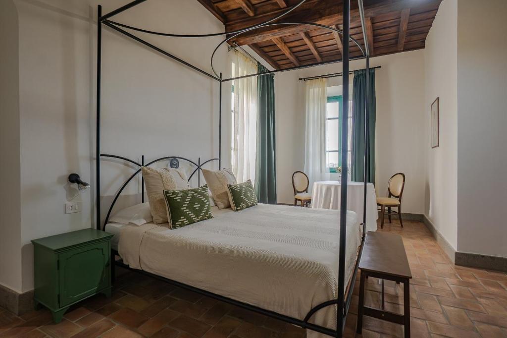 a bedroom with a bed with a metal canopy at Casale Malatesta in Velletri