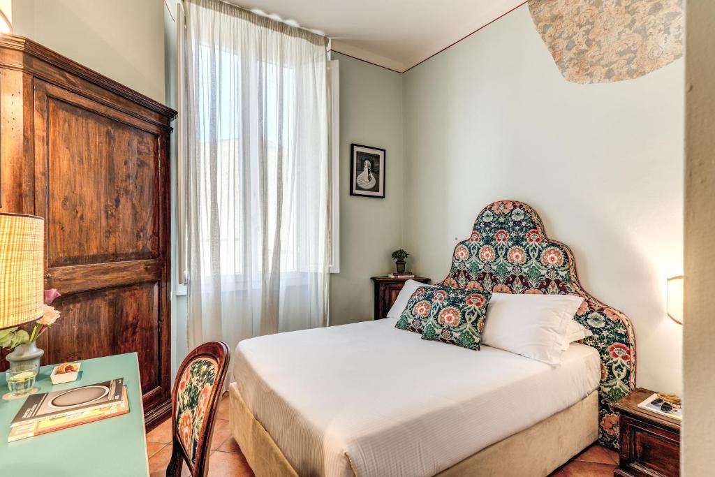 a small bedroom with a bed and a window at Hotel Galileo in Florence