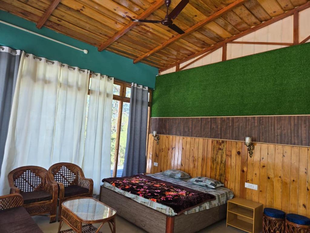 a bedroom with a bed and a green wall at Pinaka Devbhumi Homestay in Mukteshwar