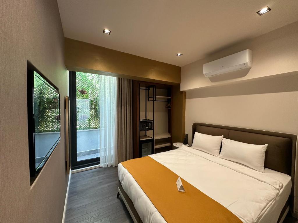 a bedroom with a large bed and a window at Smart and Simple Hotel Karakoy in Istanbul