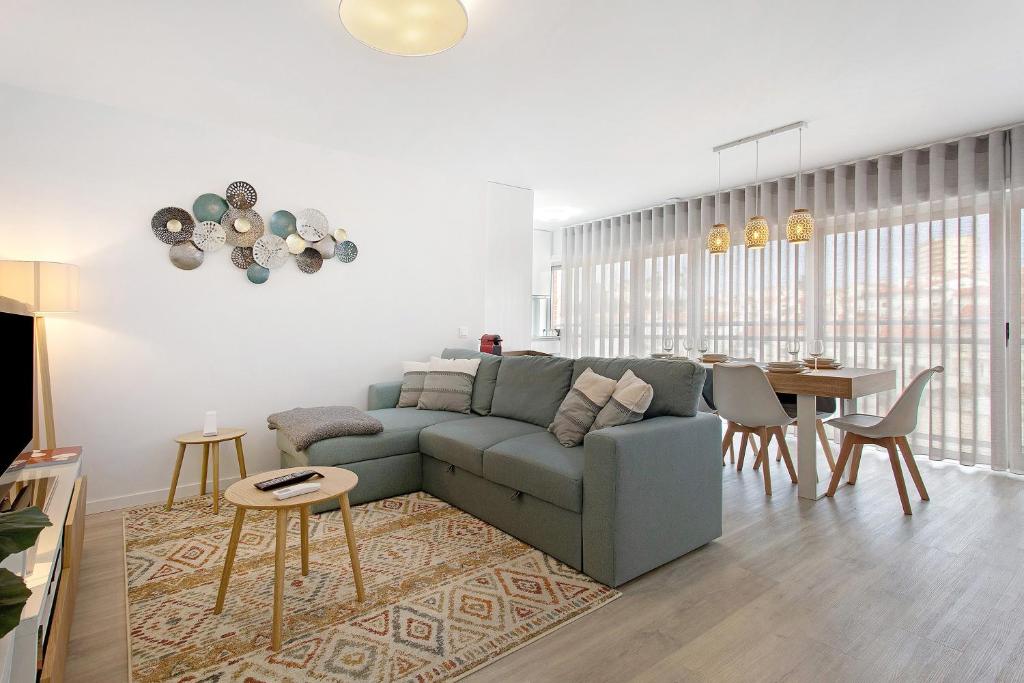 a living room with a couch and a table at Coral Beach Oasis in Figueira da Foz