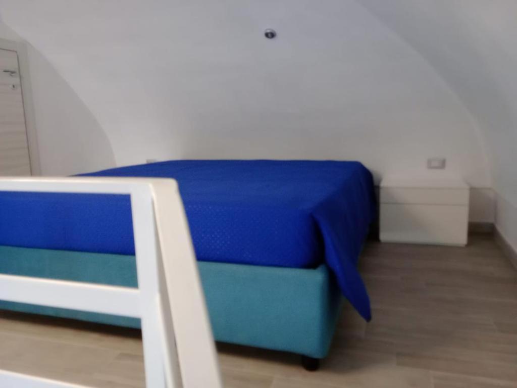 a bedroom with a blue bed in a room at La Perla del Borgo in Vieste