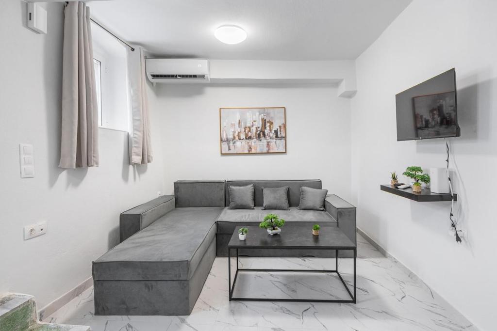 a living room with a couch and a table at Spyridoula House in Corfu