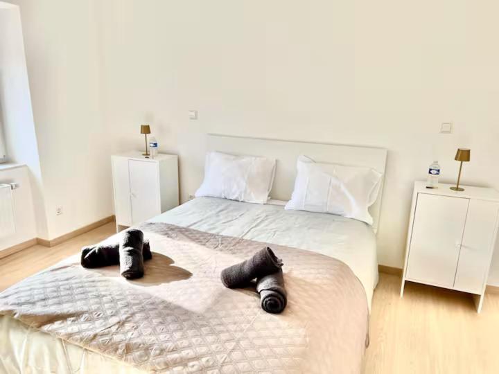 a bedroom with a bed with shoes on it at Room in new a renovated house with modern furniture in Esch-sur-Alzette