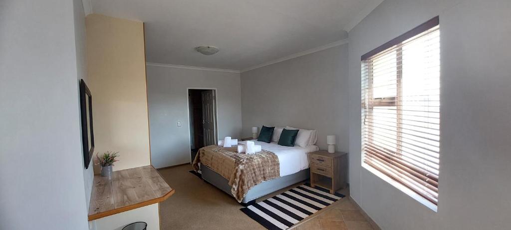 a bedroom with a bed and a window at Priai Longa 34 Self Catering in Langstrand