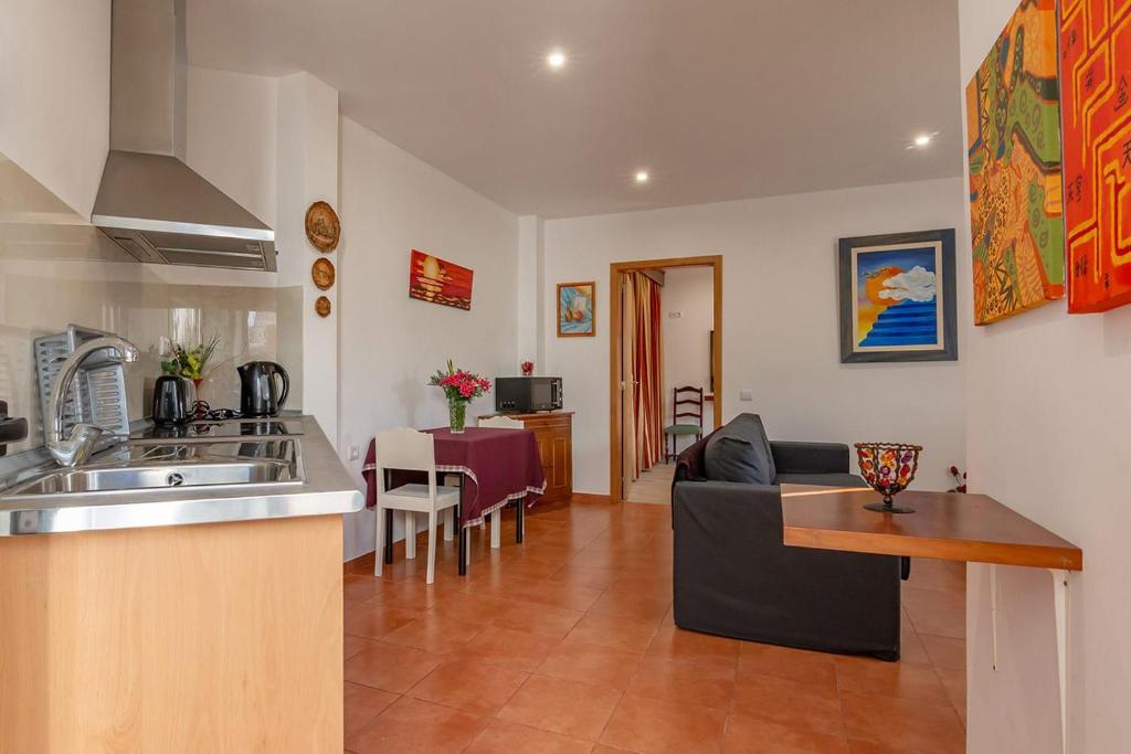 a kitchen and living room with a sink and a couch at Terrace Villa with Sea View in Santa Luzia