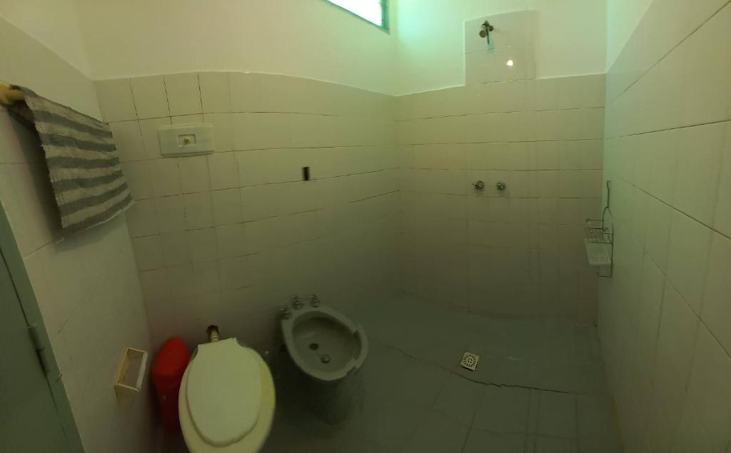 a bathroom with a toilet and a urinal at Departamento Dai in Jesús María