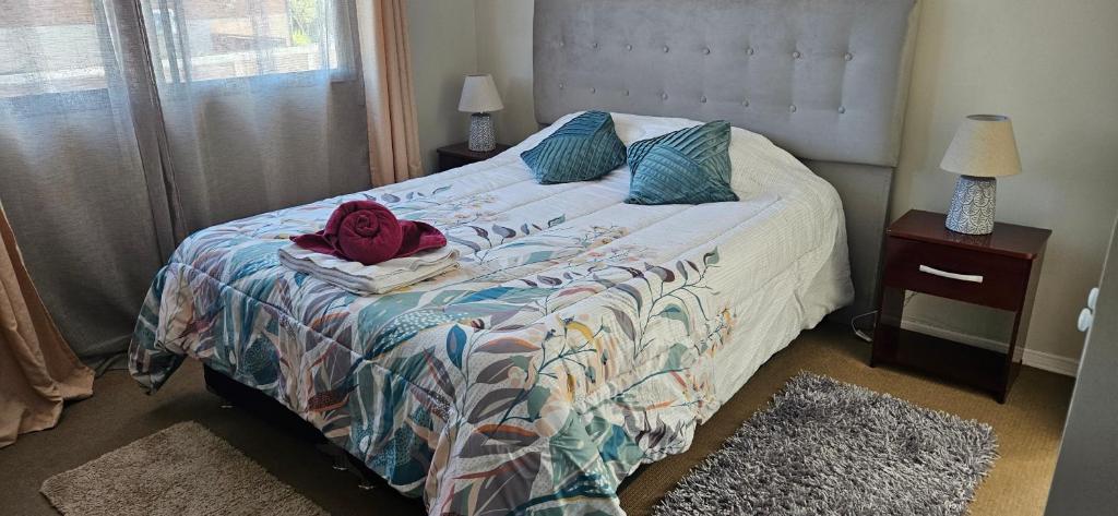 a bedroom with a bed with a red shirt on it at Naturaleza en la ciudad Habitacion Matrimonial con Baño Privado in Machalí