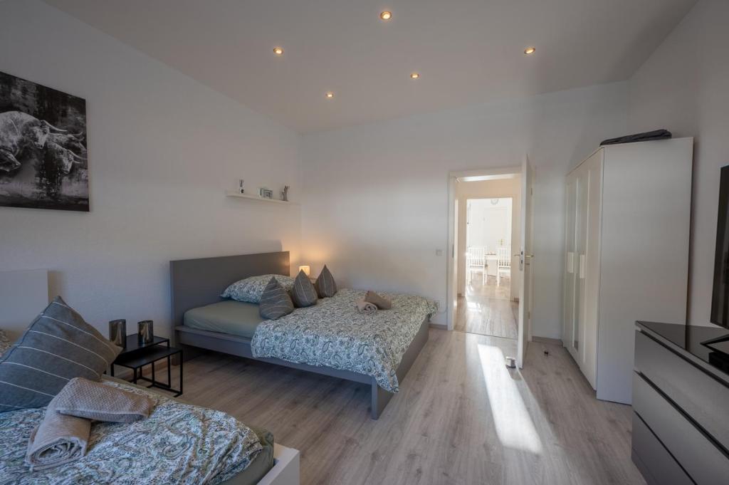 ein Schlafzimmer mit zwei Betten und ein Wohnzimmer in der Unterkunft HagenStay Eilpe 2 in Hagen