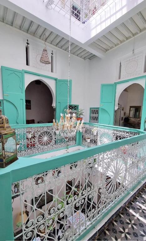 a room with a blue counter with chandeliers at Riad Nostalgie of Tetouan in Tétouan