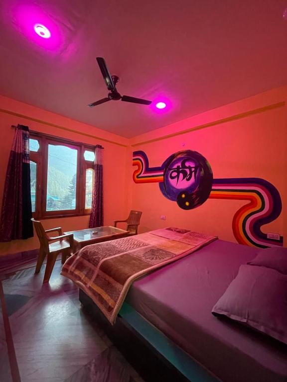 a bedroom with a bed with pink lights on it at Trippy Homestay in Kasol