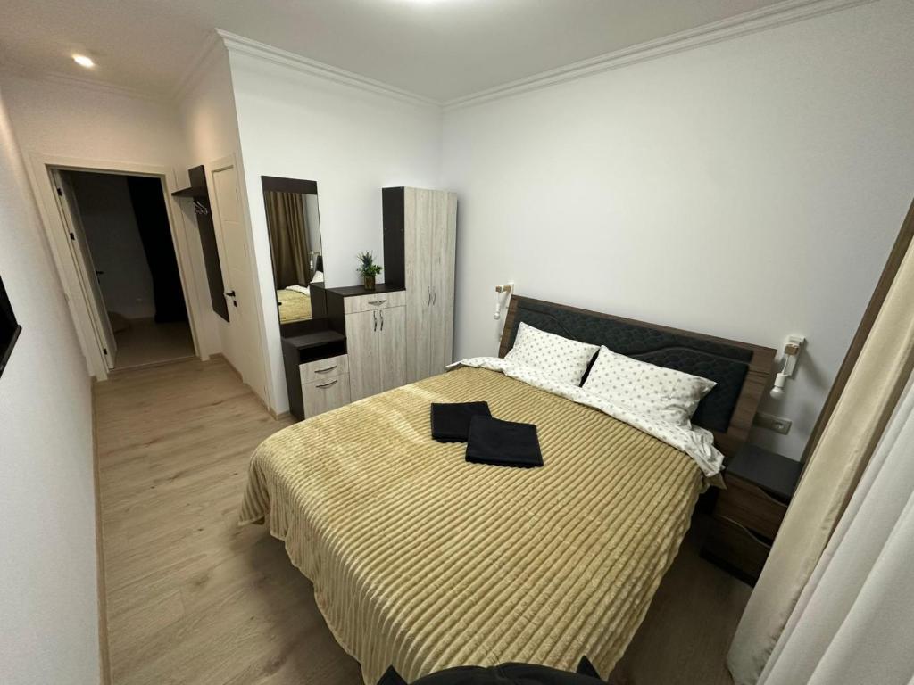 a bedroom with a large bed and a mirror at Turnul ALB in Costeşti