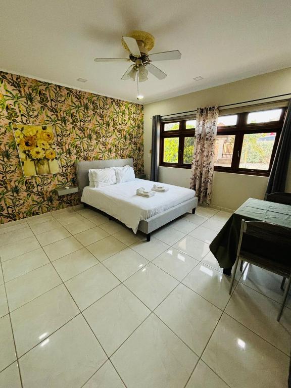 a bedroom with a bed and a ceiling fan at Relaxed Studio Near the Beach in Jan Thiel