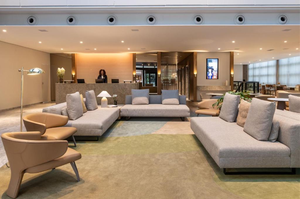 a lobby with couches and chairs in a building at Blue Tree Premium Paulista in Sao Paulo