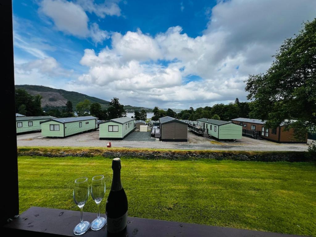a bottle of wine sitting on a table with wine glasses at Tigh Na Sealladh in Dunoon