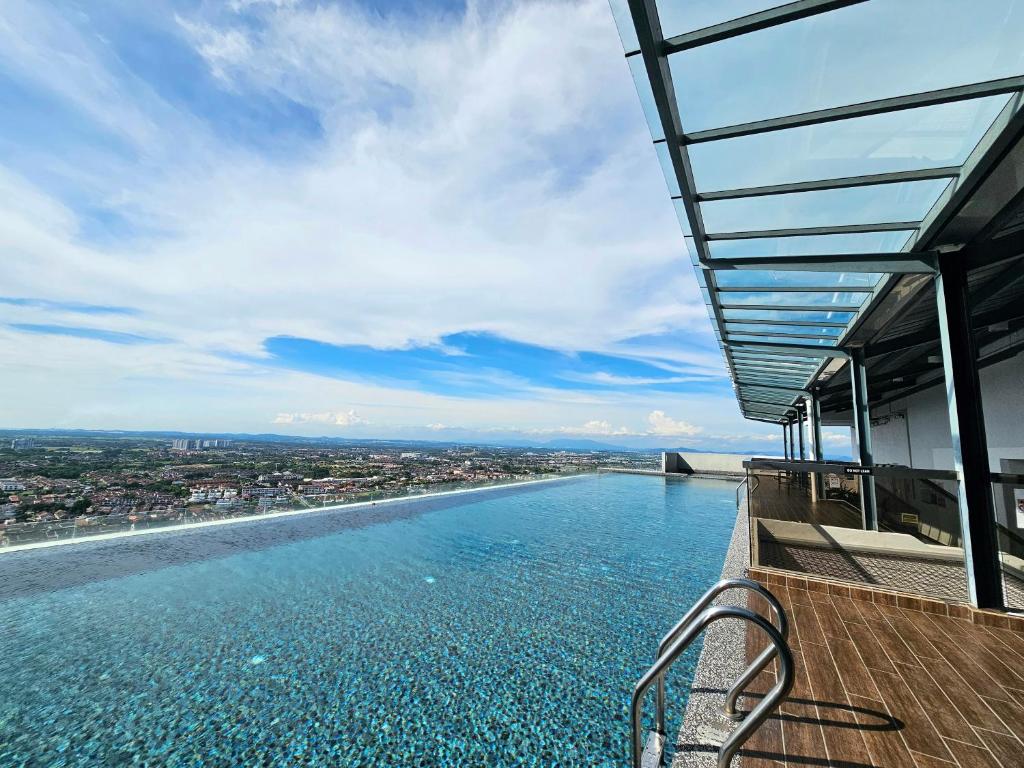 a swimming pool on top of a building with water at The Quartz Residence Peaceful Suites By GGM - Malacca City Centre in Melaka