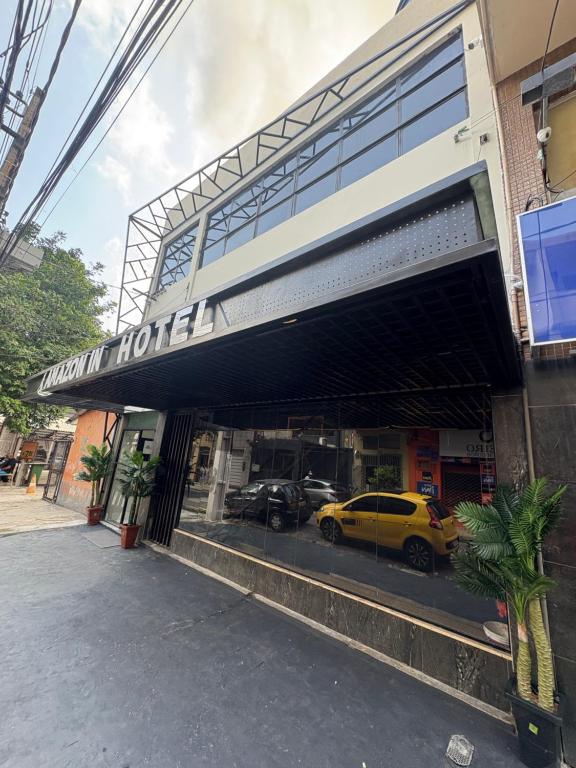 a yellow car is parked in a garage at Hotel Amazon In in Belém