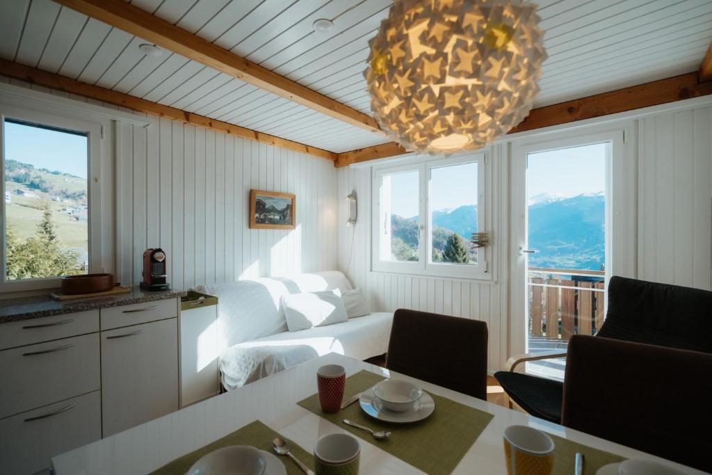 Una sala de estar con un sofá y una lámpara de araña. en Apartment Perlita, en Amden