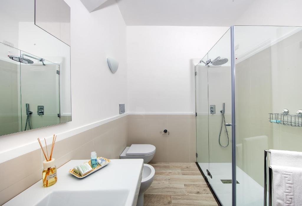 a bathroom with a toilet and a glass shower at Fuorlovado 40 in Capri