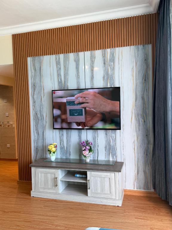 a flat screen tv on a wall in a living room at Full seaview luxury with gym,pool,jacuzzi,sauna,24x7 cafe,beach,restaurants,medical and more in Ajman 