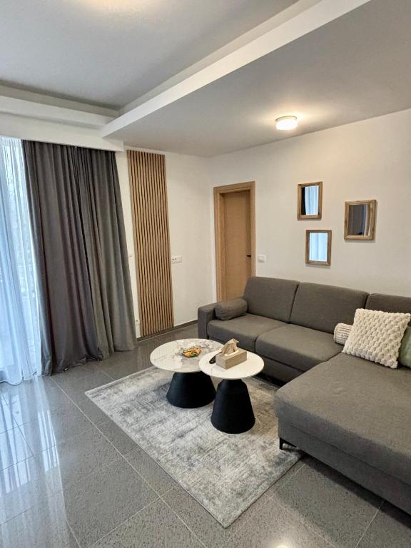 a living room with a couch and a table at View Apartments Međugorje in Međugorje