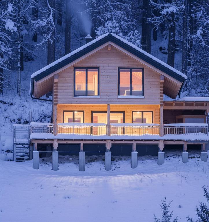 a log cabin in the woods in the snow at Bockleit'n Haus in Turnau