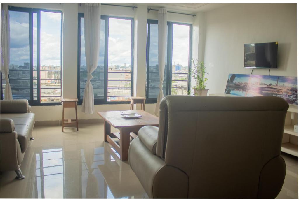 a living room with a couch and a table at Résidence 5ème Ciel in Douala