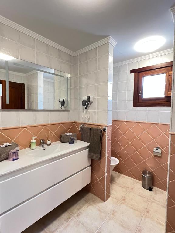 a bathroom with a sink and a mirror at Villa Petra in Tuineje