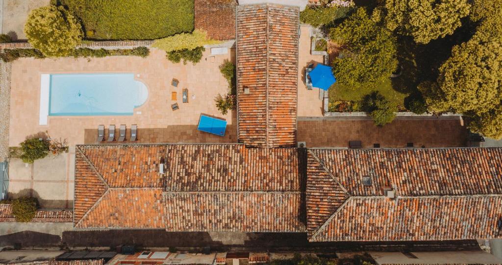 Draufsicht auf ein Gebäude mit einem gemauerten Schornstein in der Unterkunft Maison coeur de Bastide-Piscine, ping pong & salle de jeux in Vianne
