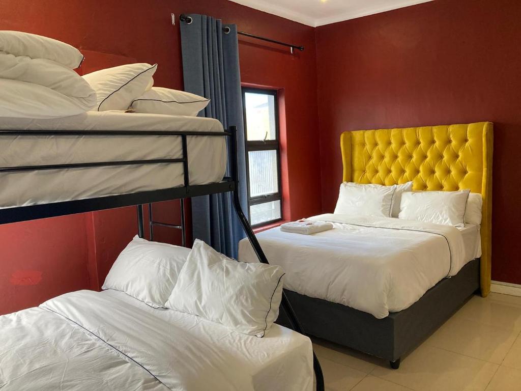 a bedroom with two bunk beds and a window at Pro Max Guesthouse Goodwood in Goodwood