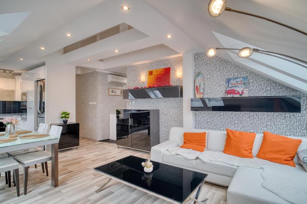 a living room with a white couch and a fireplace at CitySpace Košická in Nivy