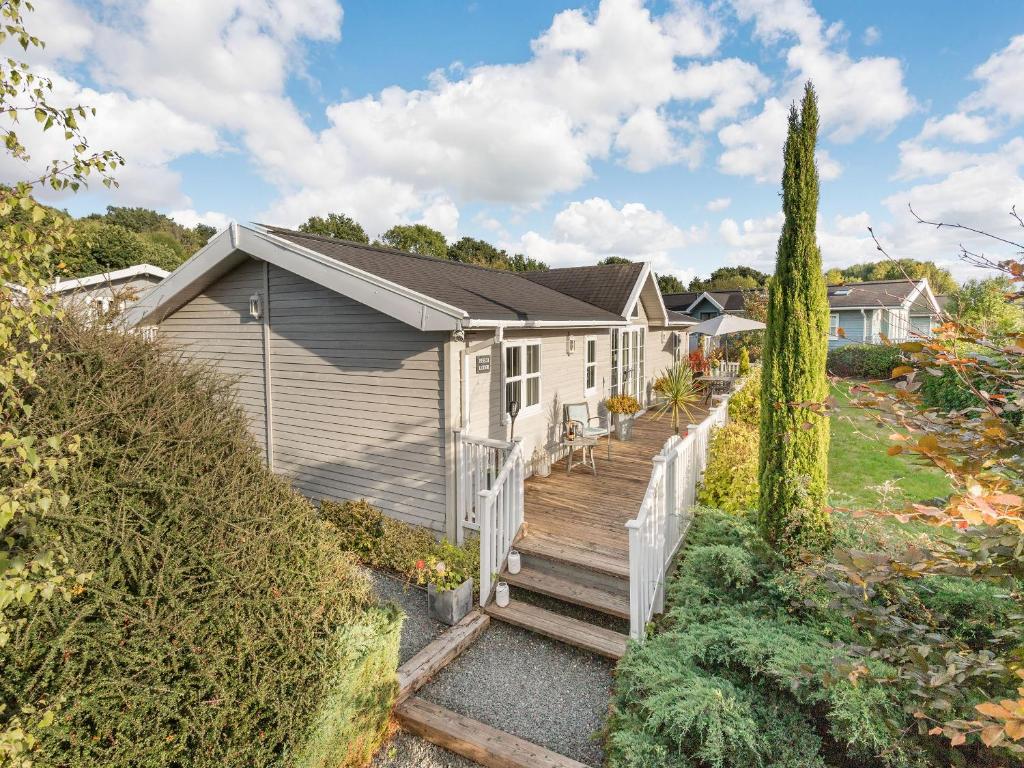 a house with a wooden staircase leading to a yard at Beech Tree Lodge in Willington