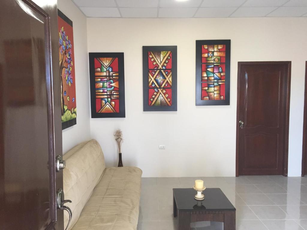 a living room with a couch and stained glass windows at NCG Suite in Guayaquil