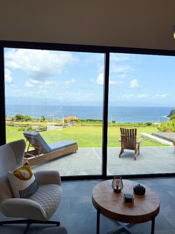 a living room with a view of the ocean at Casa Al Mare in Canto da Areia