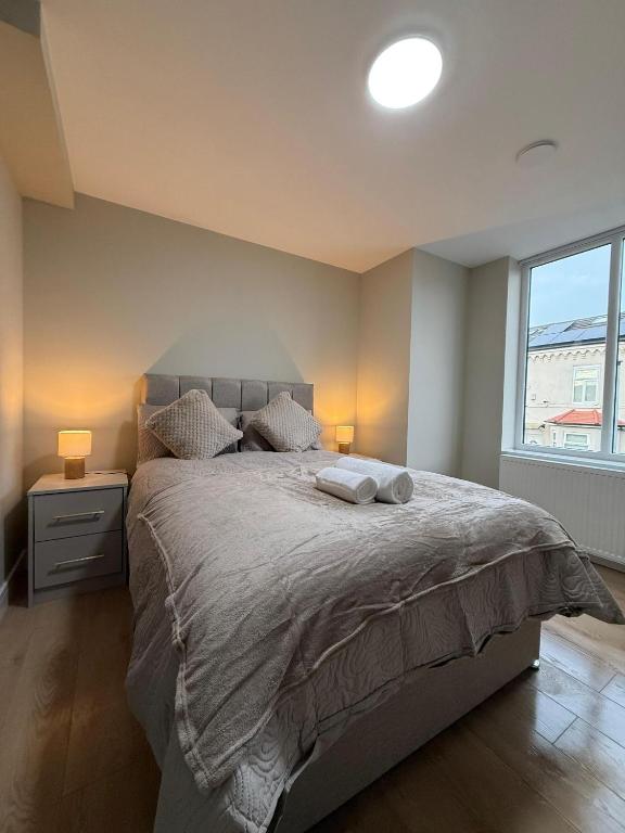 a bedroom with a large bed and a window at Britlodge Home in Manchester