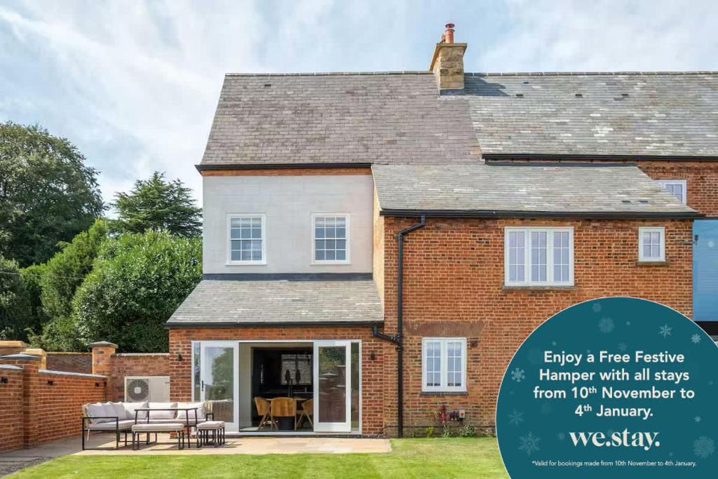 a brick house with a sign that says enjoy free testing happenivist with all apps at The Talbot - Exclusive Home with Hot Tub in Welford